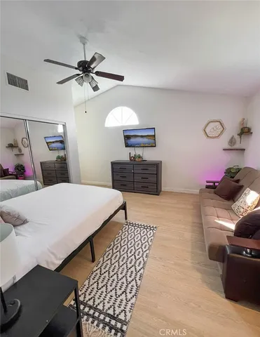 a bedroom with a bed and a chandelier