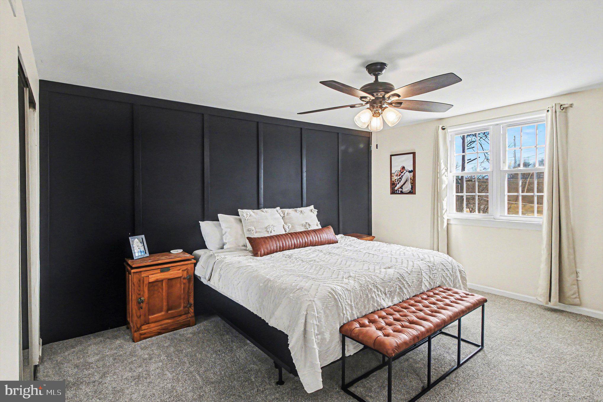 822 Hancock Street Ridley Park, PA 19033 - Photo 17 of 30 a bedroom with a bed and a chandelier
