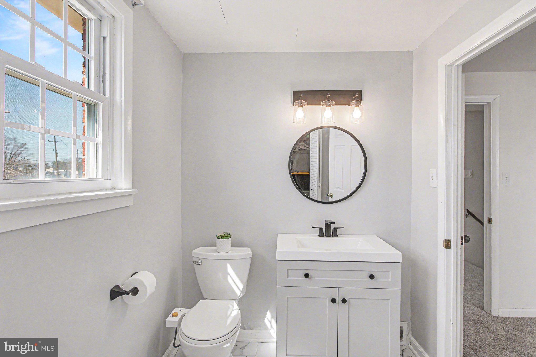 822 Hancock Street Ridley Park, PA 19033 - Photo 19 of 30 a bathroom with a toilet a sink and a mirror