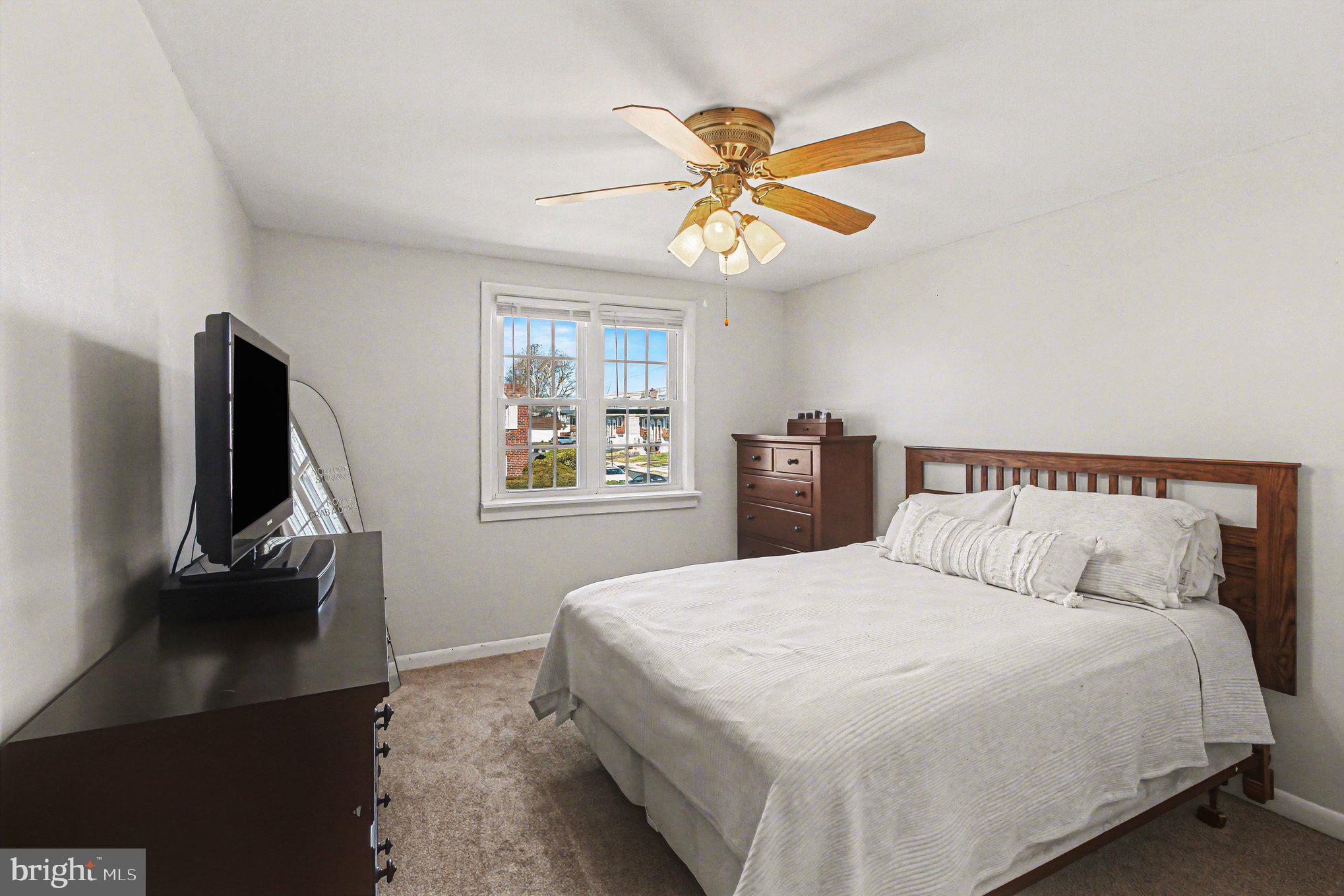 822 Hancock Street Ridley Park, PA 19033 - Photo 23 of 30 a bedroom with a bed and a chandelier