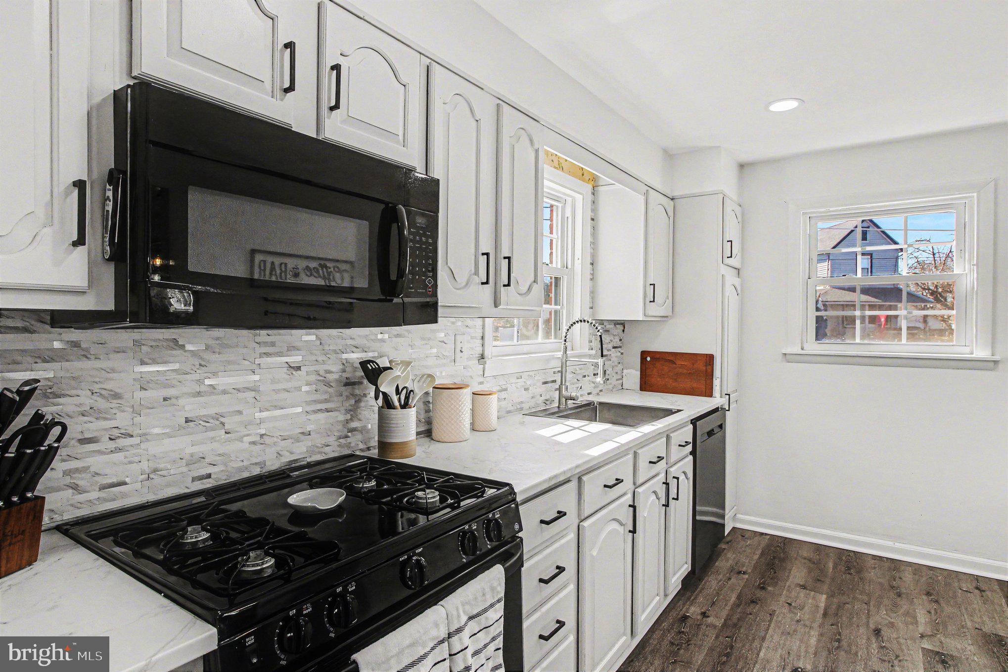 822 Hancock Street Ridley Park, PA 19033 - Photo 10 of 30 a kitchen with stainless steel appliances a stove sink and cabinets