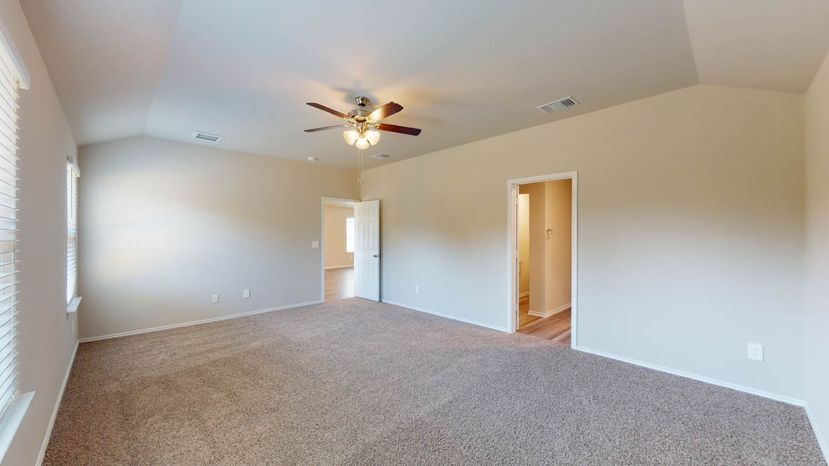 509 Hector Loop Georgetown, TX 78626 - Photo 16 of 31 A spacious, naturally illuminated room featuring vaulted ceilings and a practical ceiling fan.