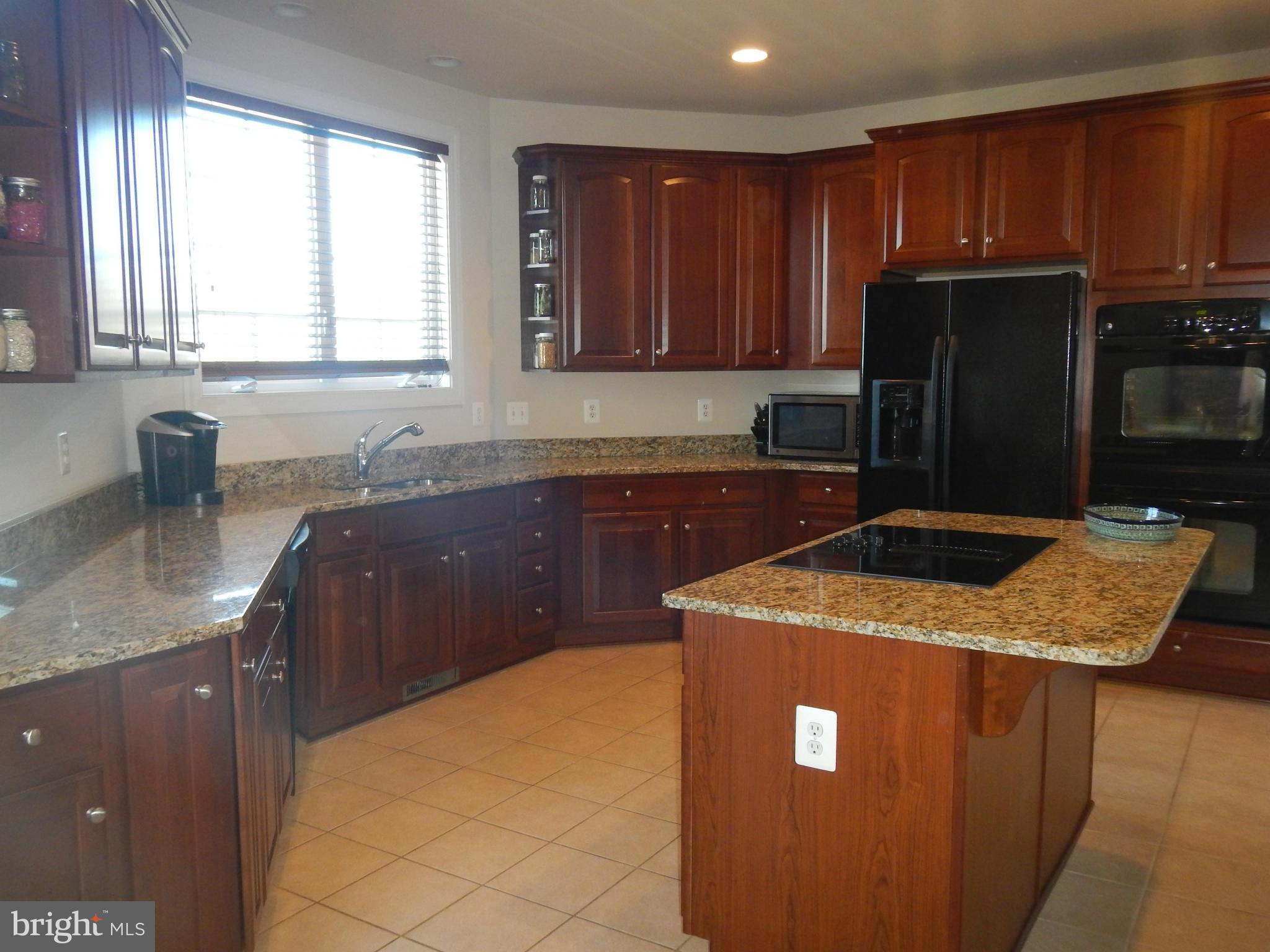 13602 Union Church Road Sumerduck, VA 22742 - Photo 13 of 30 a kitchen with kitchen island granite countertop cabinets sink and stainless steel appliances