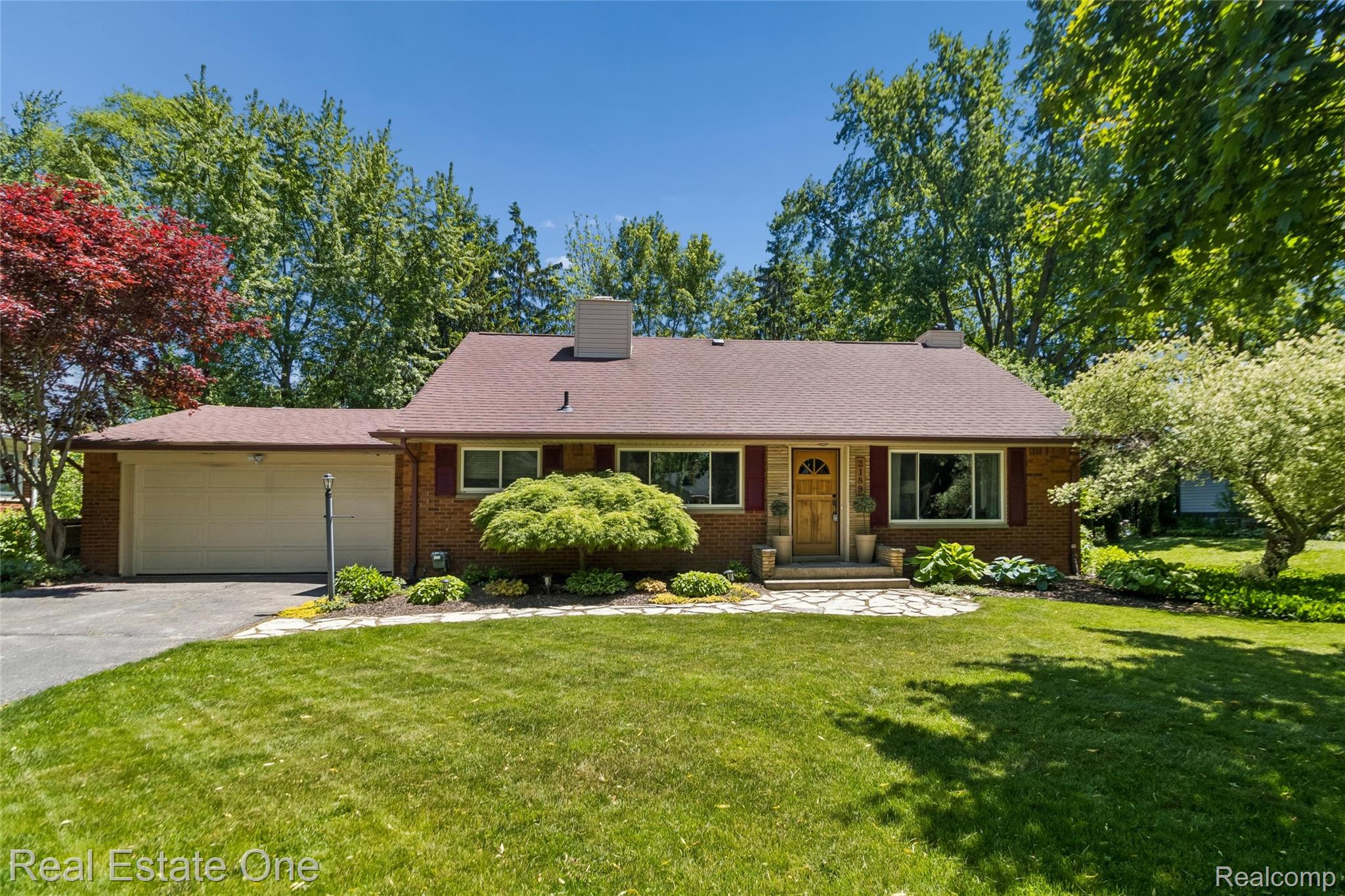 2189 Devonshire Road Bloomfield Hills, MI 48302 - Photo 39 of 50 Brick facade residence with a stone pathway leading to the front entry