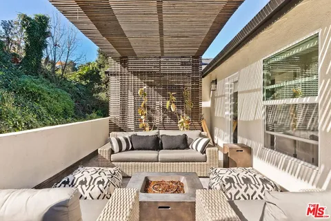 a balcony with furniture and a large window