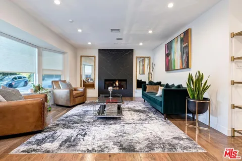 a living room with furniture potted plant and a table