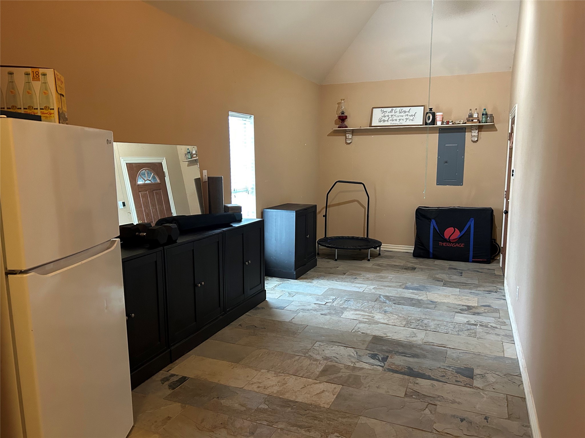 329 Flash Circle Luling, TX 78648 - Photo 26 of 32 Richly textured stone tile floors run under a vaulted ceiling in this versatile space.