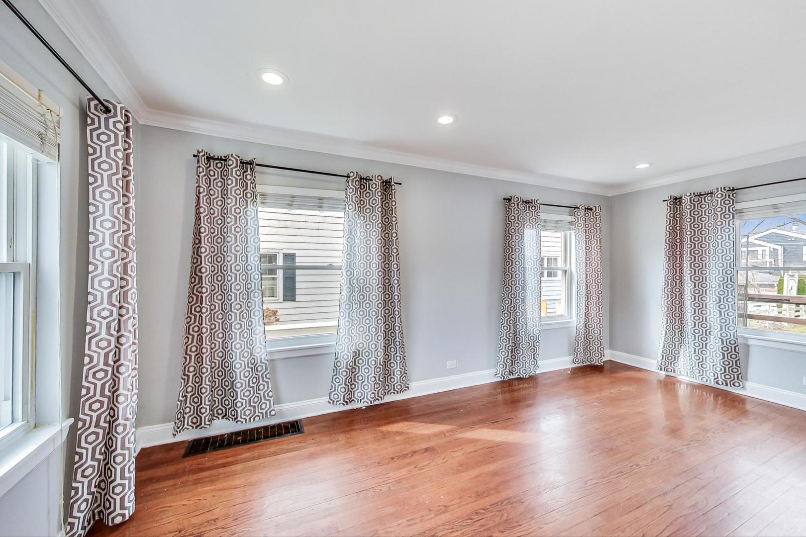 402 North Main Street Mount Prospect, IL 60056 - Photo 4 of 19 a view of an empty room with glass door and wooden floor
