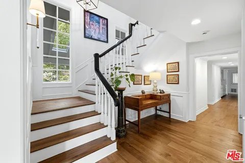 a view of entryway dining room and hall with wooden floor