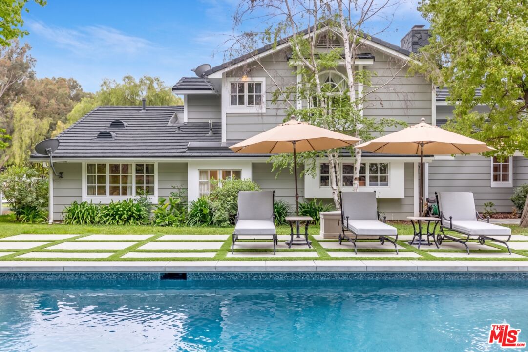 24317 Bridle Trail Road Hidden Hills, CA 91302 - Photo 27 of 37 a front view of a house with swimming pool and porch