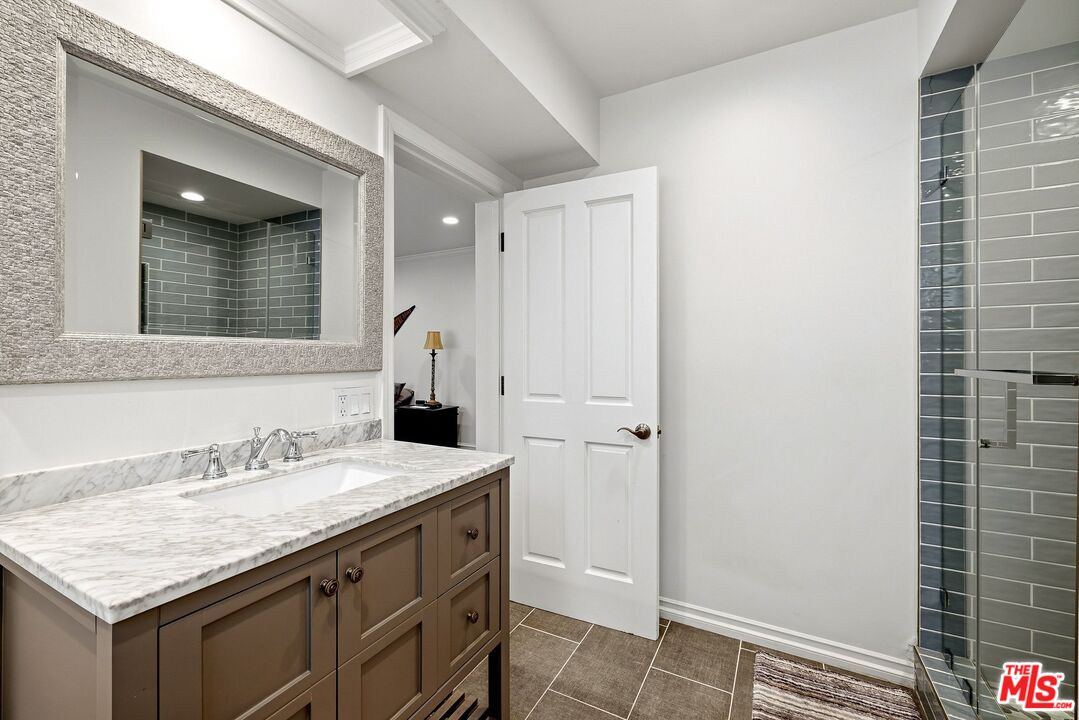 24317 Bridle Trail Road Hidden Hills, CA 91302 - Photo 32 of 37 a bathroom with a sink and a mirror