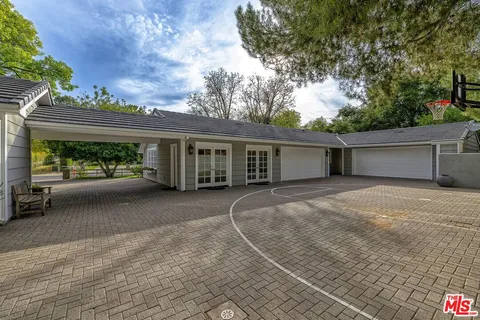 a view of a house with a backyard and a garage