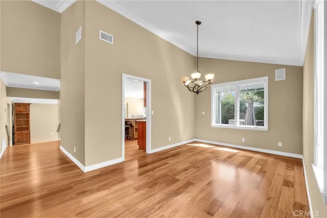 a view of a room with window wooden floor and a chandelier