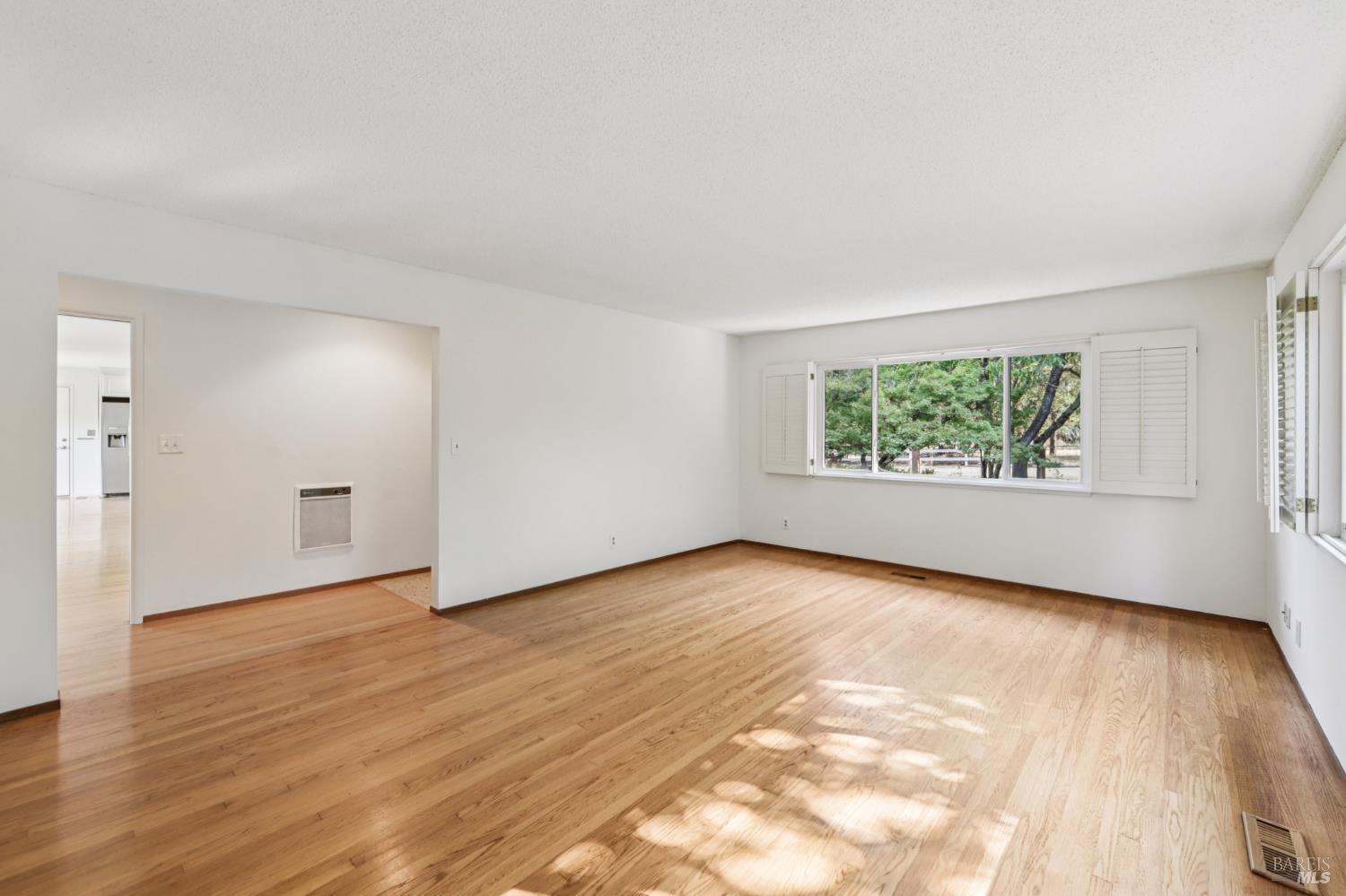 1050 Sunset Road Napa, CA 94558 - Photo 13 of 67 an empty room with wooden floor and windows
