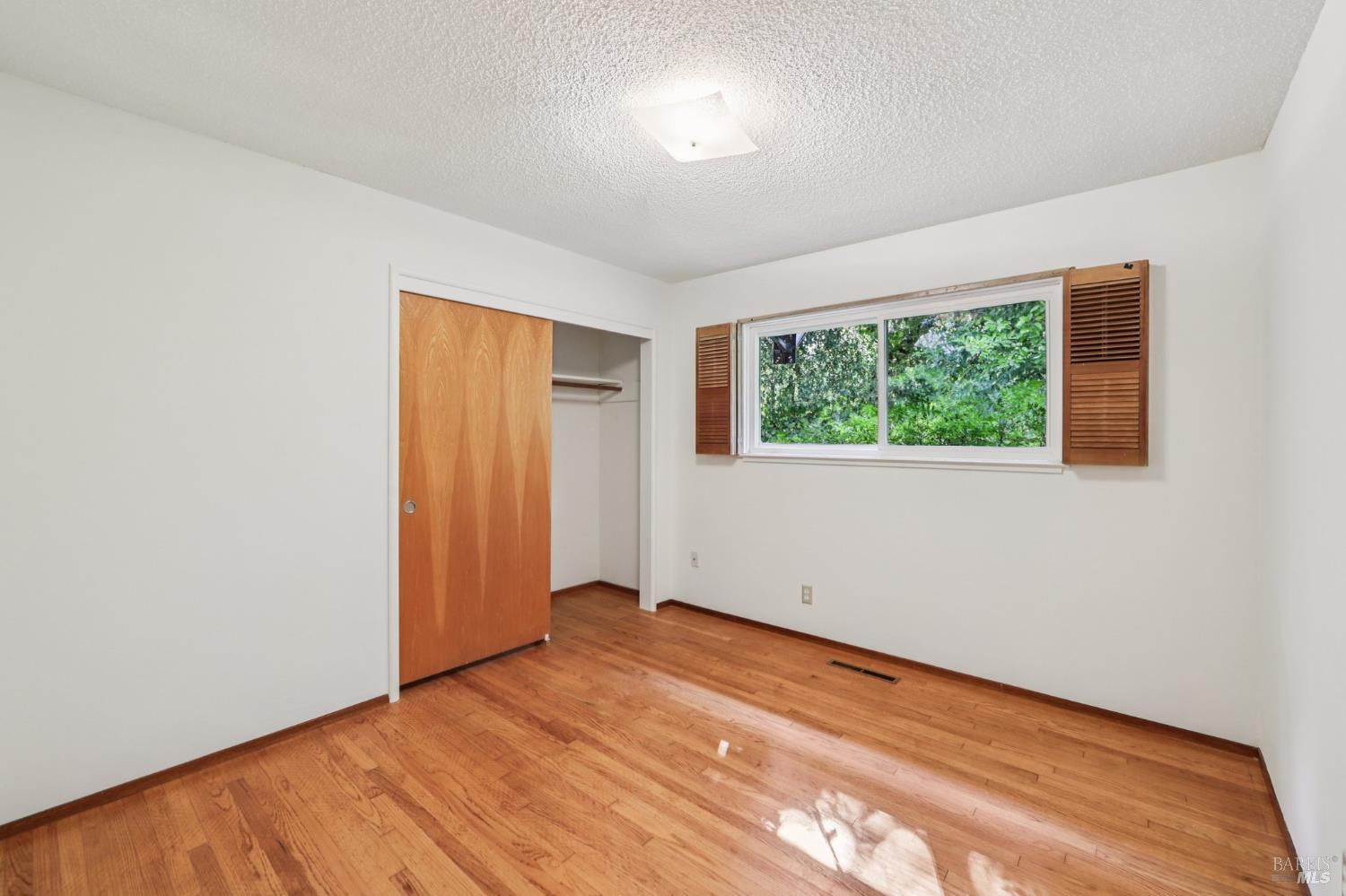 1050 Sunset Road Napa, CA 94558 - Photo 15 of 67 an empty room with wooden floor and windows