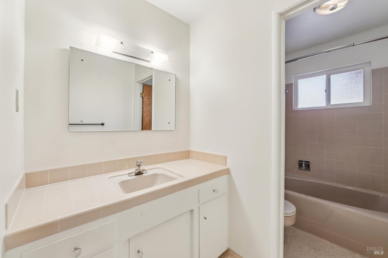 1050 Sunset Road Napa, CA 94558 - Photo 20 of 67 a bathroom with a sink a toilet a shower and a mirror