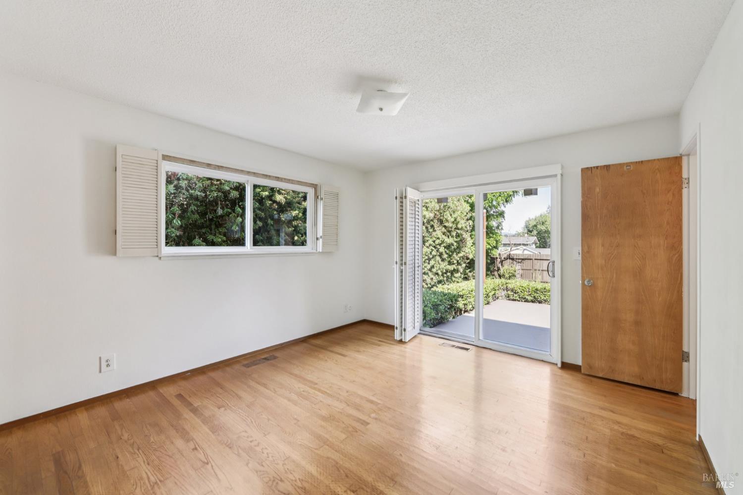 1050 Sunset Road Napa, CA 94558 - Photo 23 of 67 a view of an empty room with a window and wooden floor