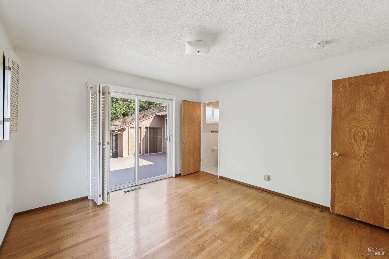 1050 Sunset Road Napa, CA 94558 - Photo 25 of 67 a view of empty room with wooden floor and fan