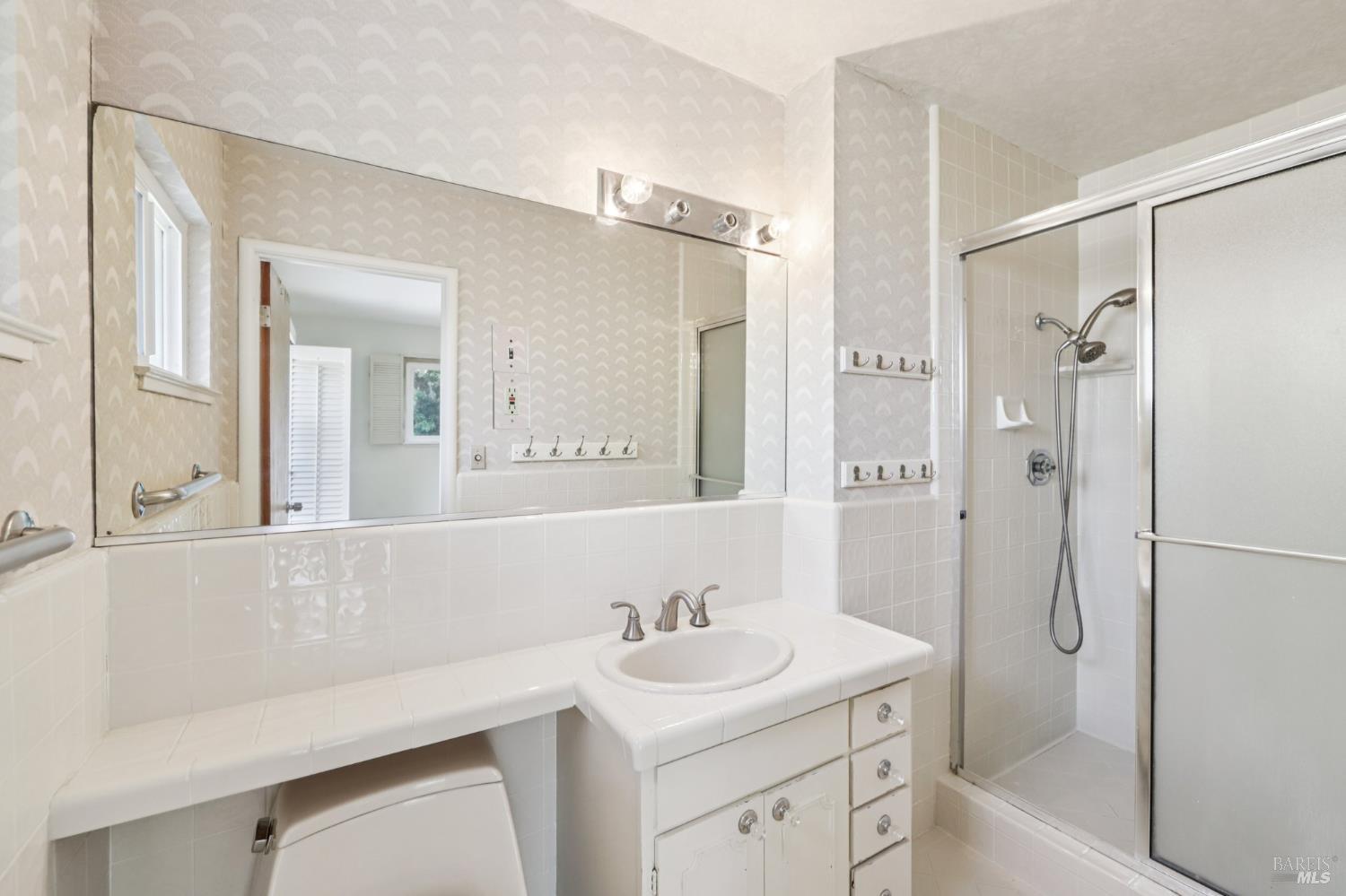 1050 Sunset Road Napa, CA 94558 - Photo 26 of 67 a bathroom with a sink a mirror a vanity and shower