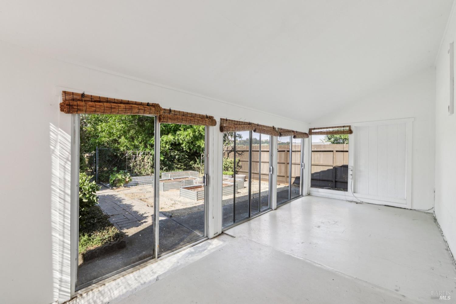 1050 Sunset Road Napa, CA 94558 - Photo 27 of 67 an empty room with floor to ceiling window and an outdoor view