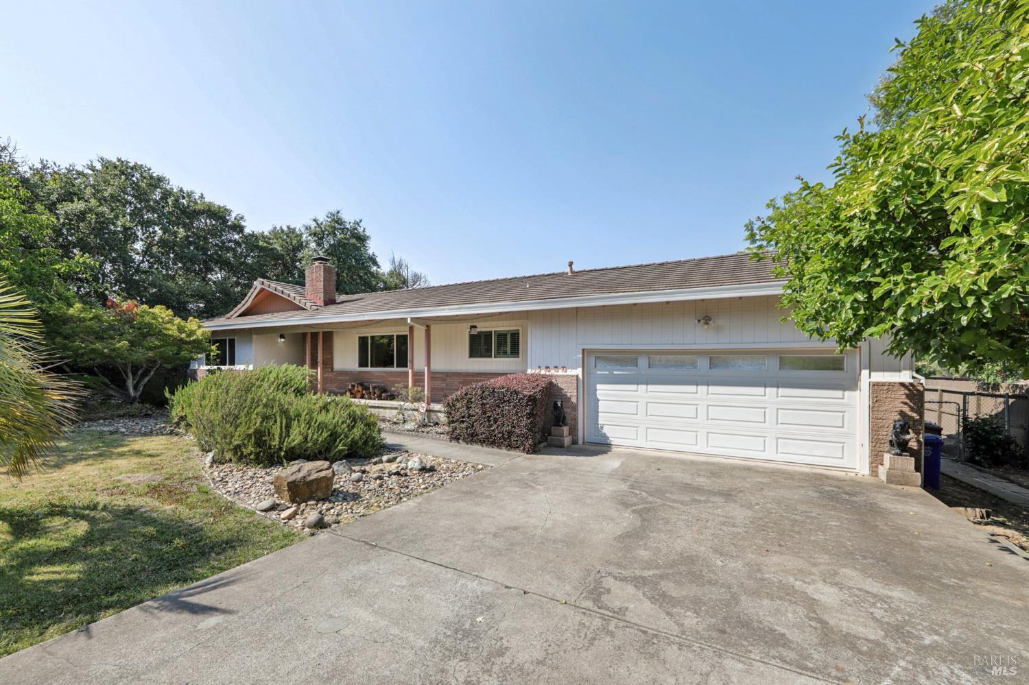 1050 Sunset Road Napa, CA 94558 - Photo 51 of 67 a front view of a house with a yard and potted plants