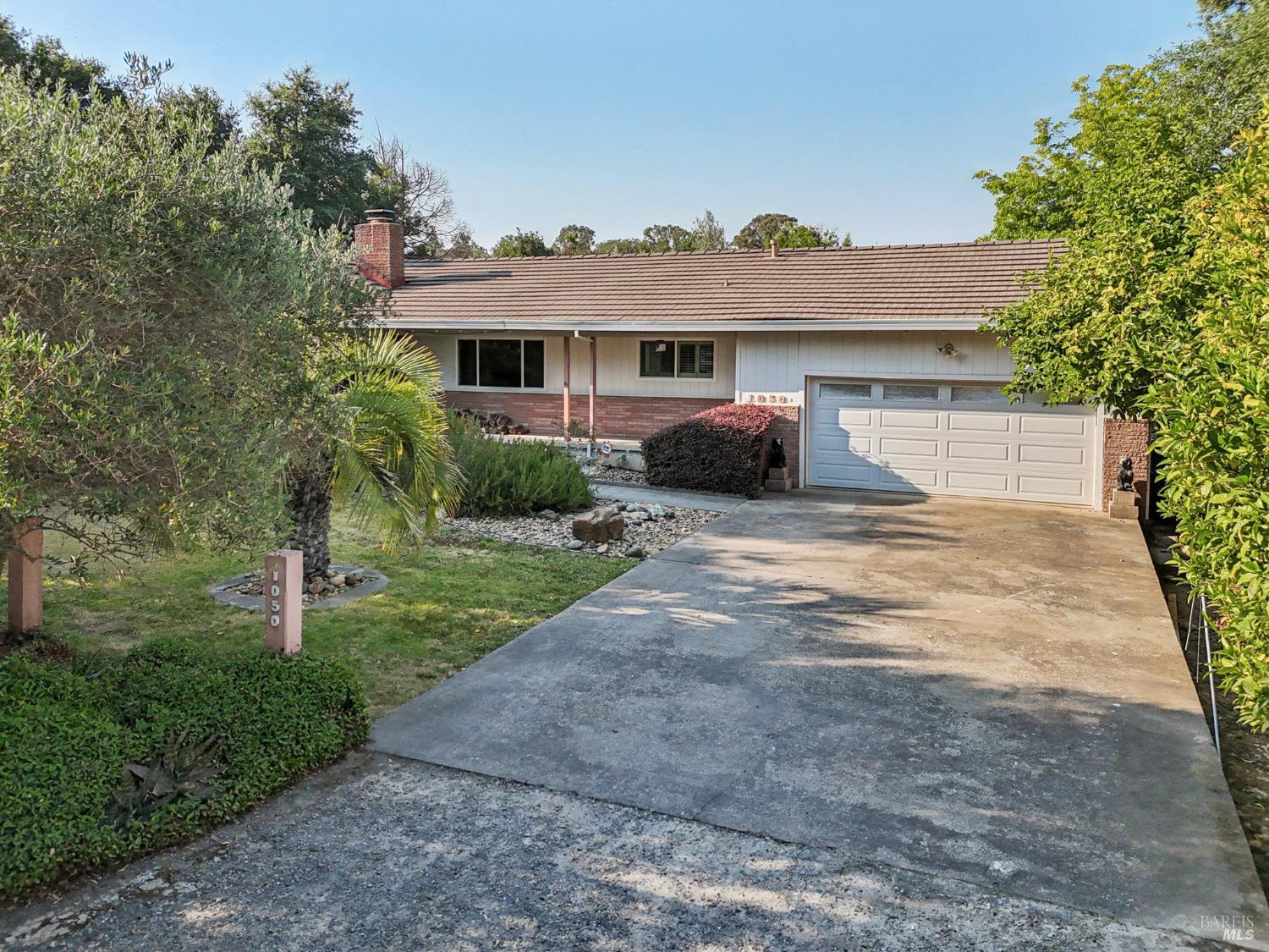1050 Sunset Road Napa, CA 94558 - Photo 53 of 67 a front view of a house with a yard and potted plants