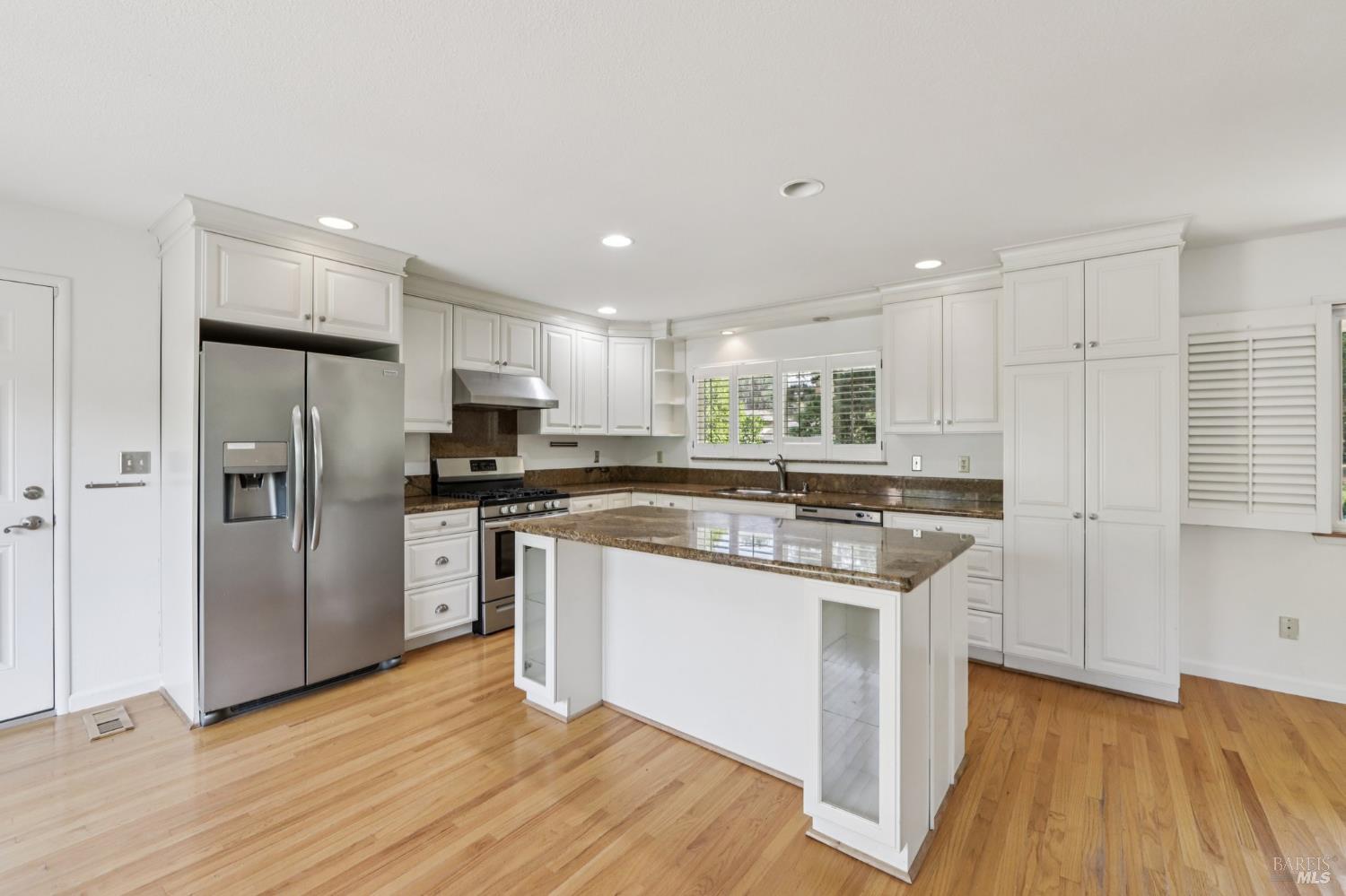 1050 Sunset Road Napa, CA 94558 - Photo 8 of 67 a kitchen with stainless steel appliances granite countertop a refrigerator a stove and a sink with wooden floor