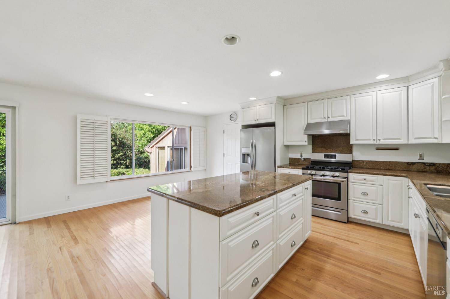 1050 Sunset Road Napa, CA 94558 - Photo 10 of 67 a kitchen with granite countertop white cabinets and white appliances