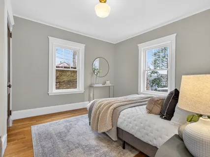 a bedroom with a bed and window