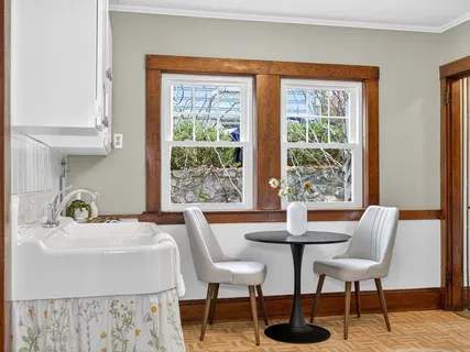 a dining room with furniture and wooden floor