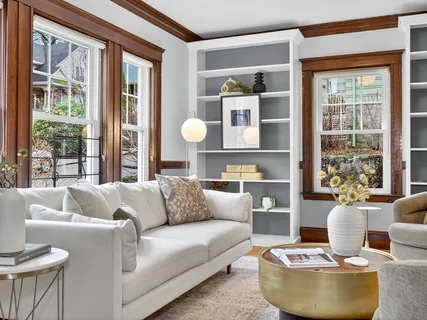 a living room with furniture and a potted plant