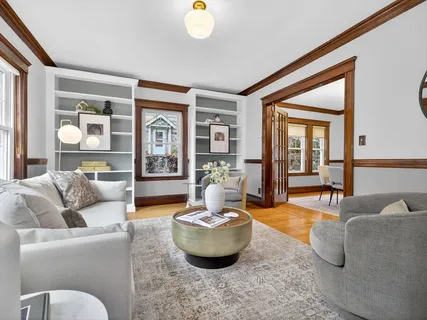 a living room with furniture and a potted plant