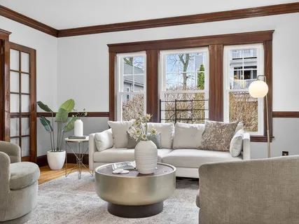 a living room with furniture and a potted plant