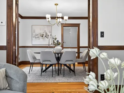 a view of a dining room with furniture and chandelier
