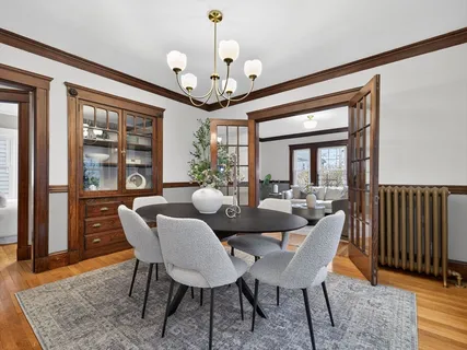 a view of a dining room with furniture wooden floor and chandelier
