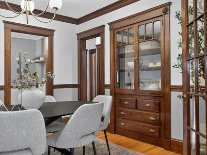 a view of a dining room with furniture and a window