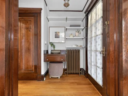 a room with wooden floor and a window