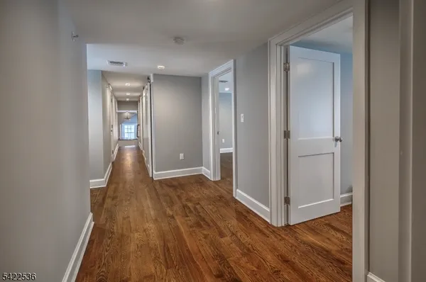 a view of a room with wooden floor