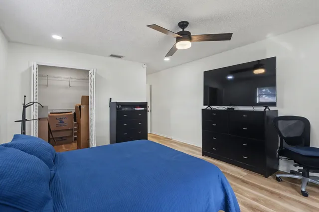 a bedroom with a bed and a dresser