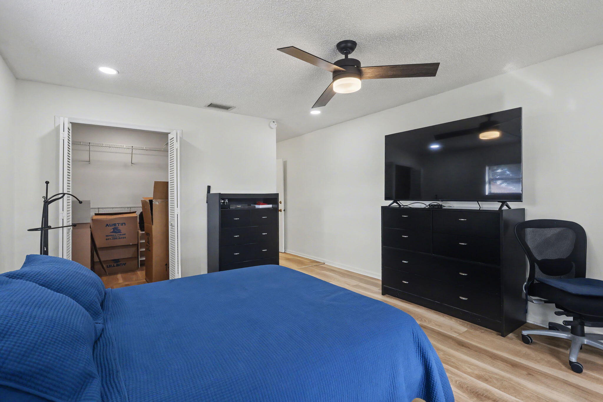 4635 Apple Tree Circle, Unit A Boynton Beach, FL 33436 - Photo 24 of 25 a bedroom with a bed and a dresser