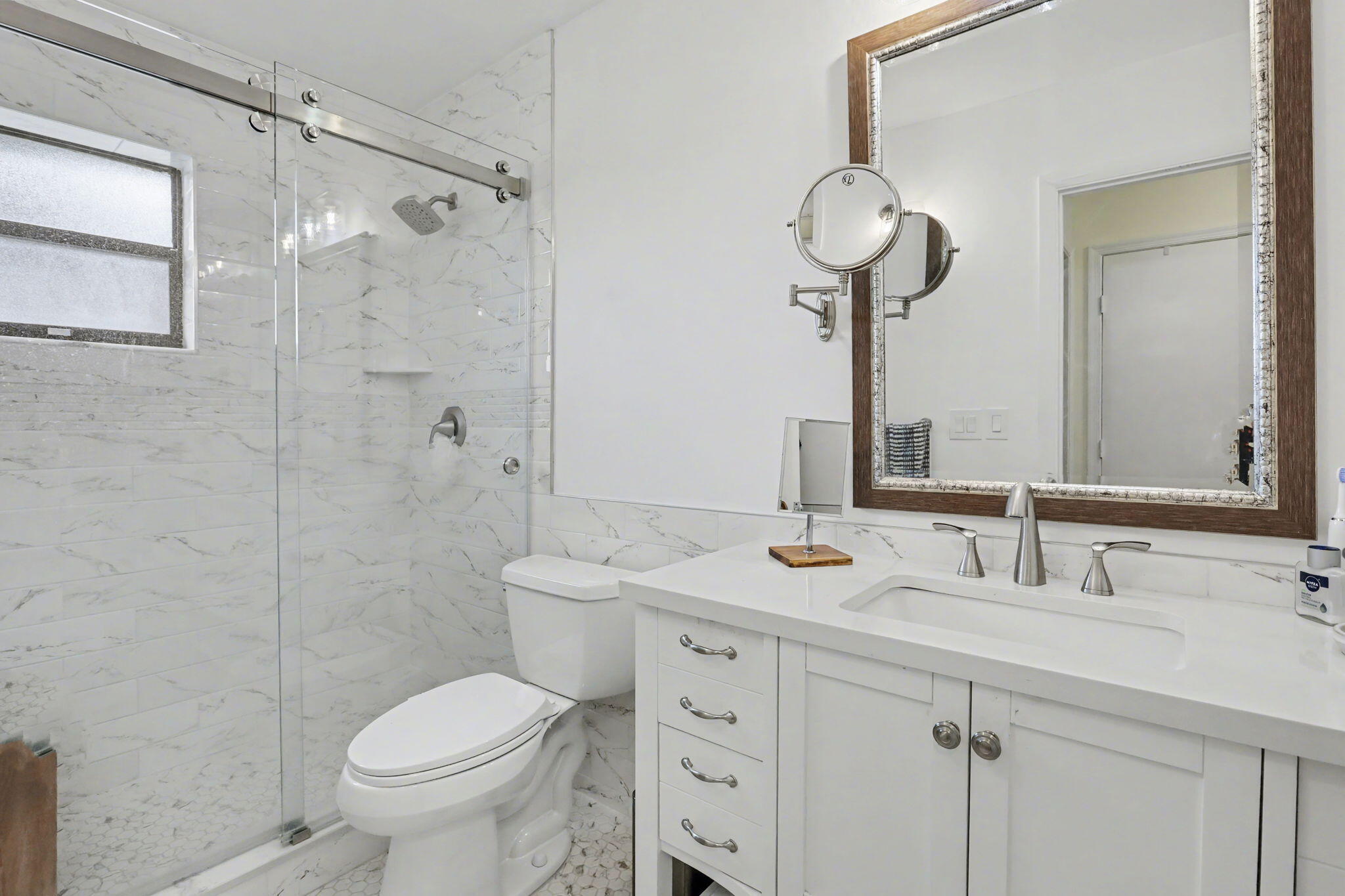4635 Apple Tree Circle, Unit A Boynton Beach, FL 33436 - Photo 25 of 25 a bathroom with a toilet sink and mirror