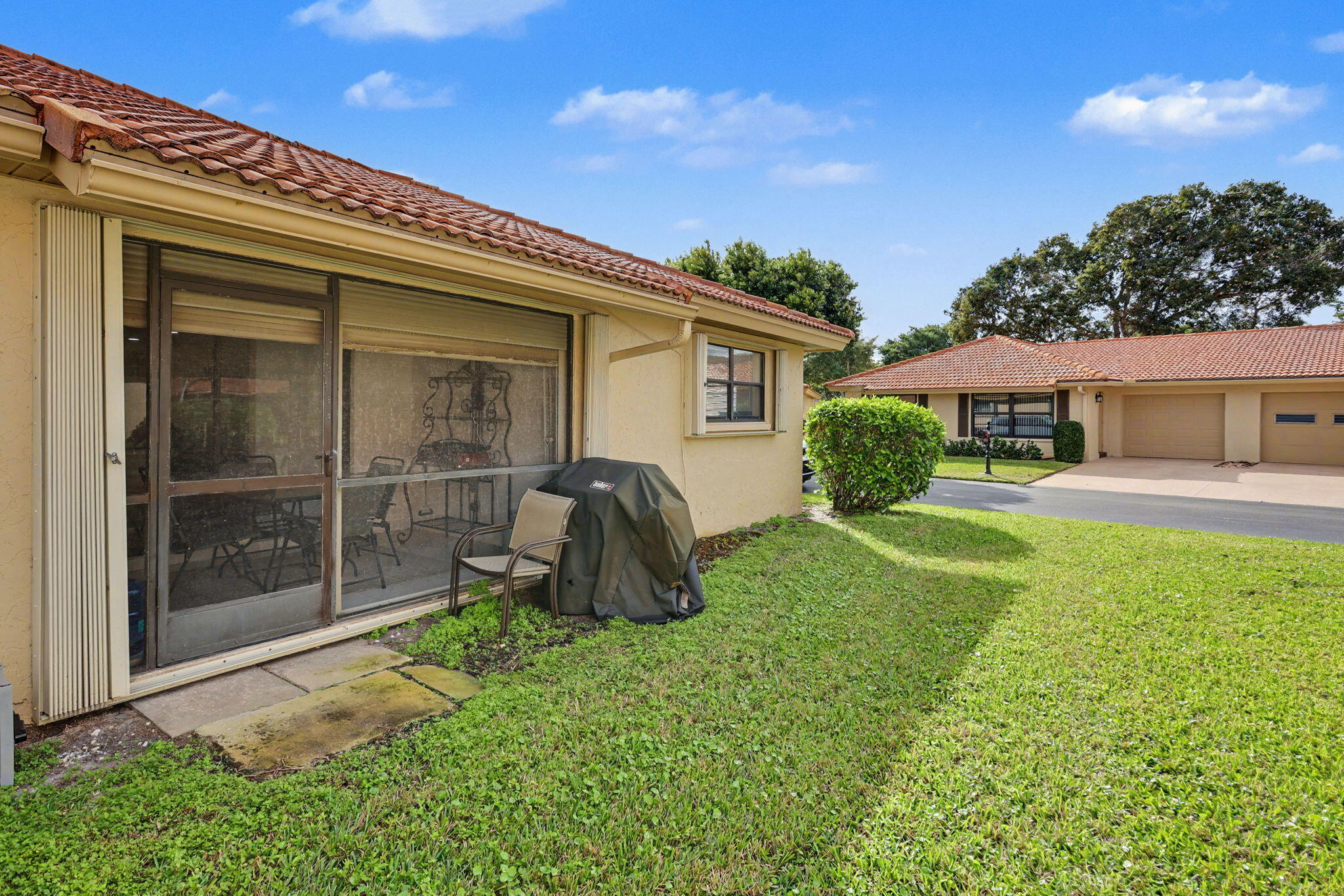 4635 Apple Tree Circle, Unit A Boynton Beach, FL 33436 - Photo 8 of 25 a view of a house with backyard sitting area and garden