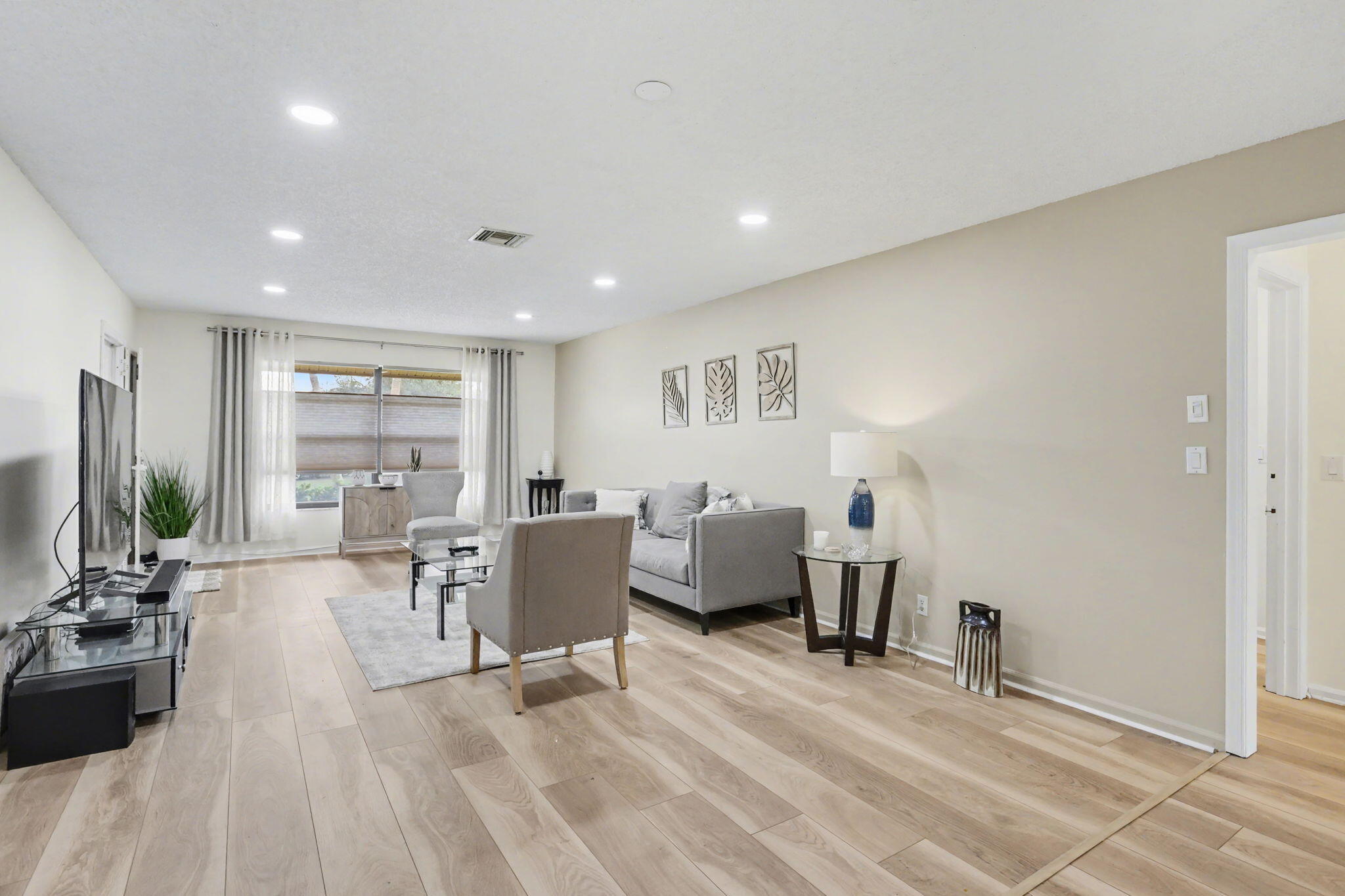 4635 Apple Tree Circle, Unit A Boynton Beach, FL 33436 - Photo 9 of 25 a living room with furniture and a large window