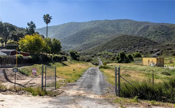 a view of a dry yard with mountains in the background