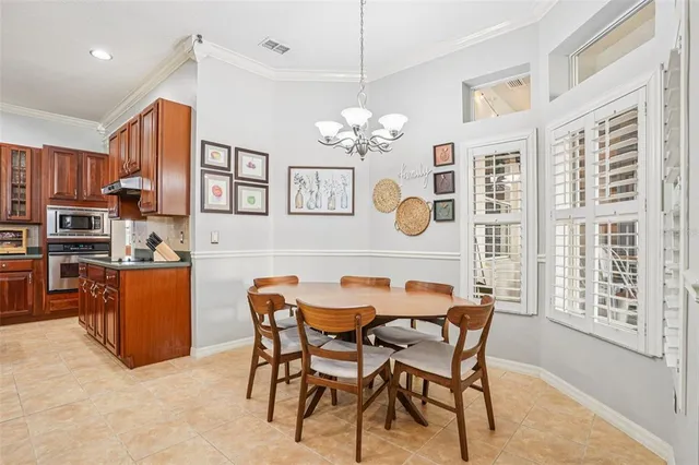 a view of a dining room with furniture a chandelier and wooden floor