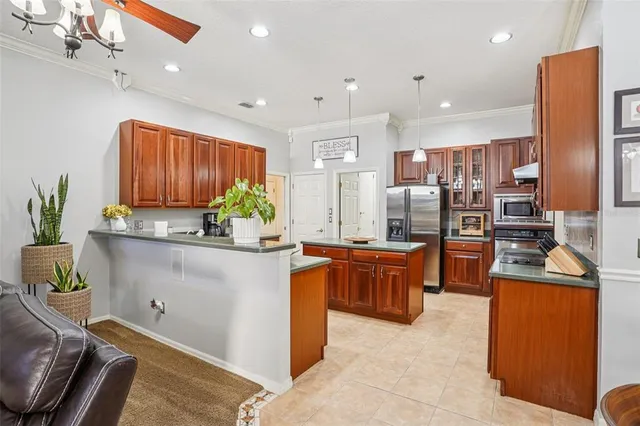 a kitchen with granite countertop a counter space cabinets stainless steel appliances and a counter top space