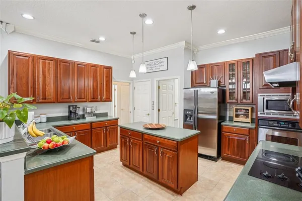a kitchen with stainless steel appliances granite countertop a sink stove and refrigerator