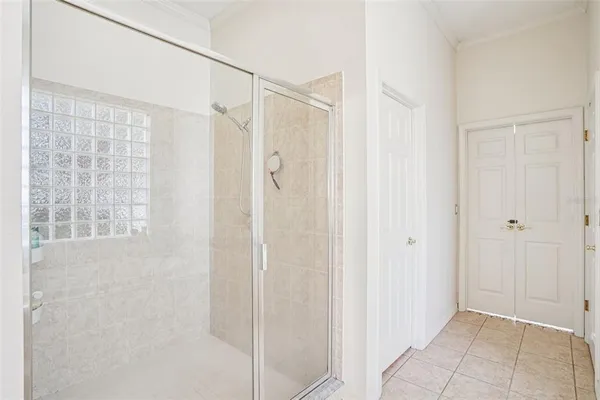 a bathroom with a shower and a glass door