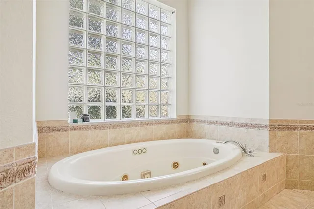 a bathroom with bathtub and shower