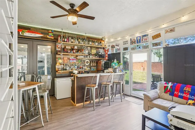 a dining room with wooden floor and furniture